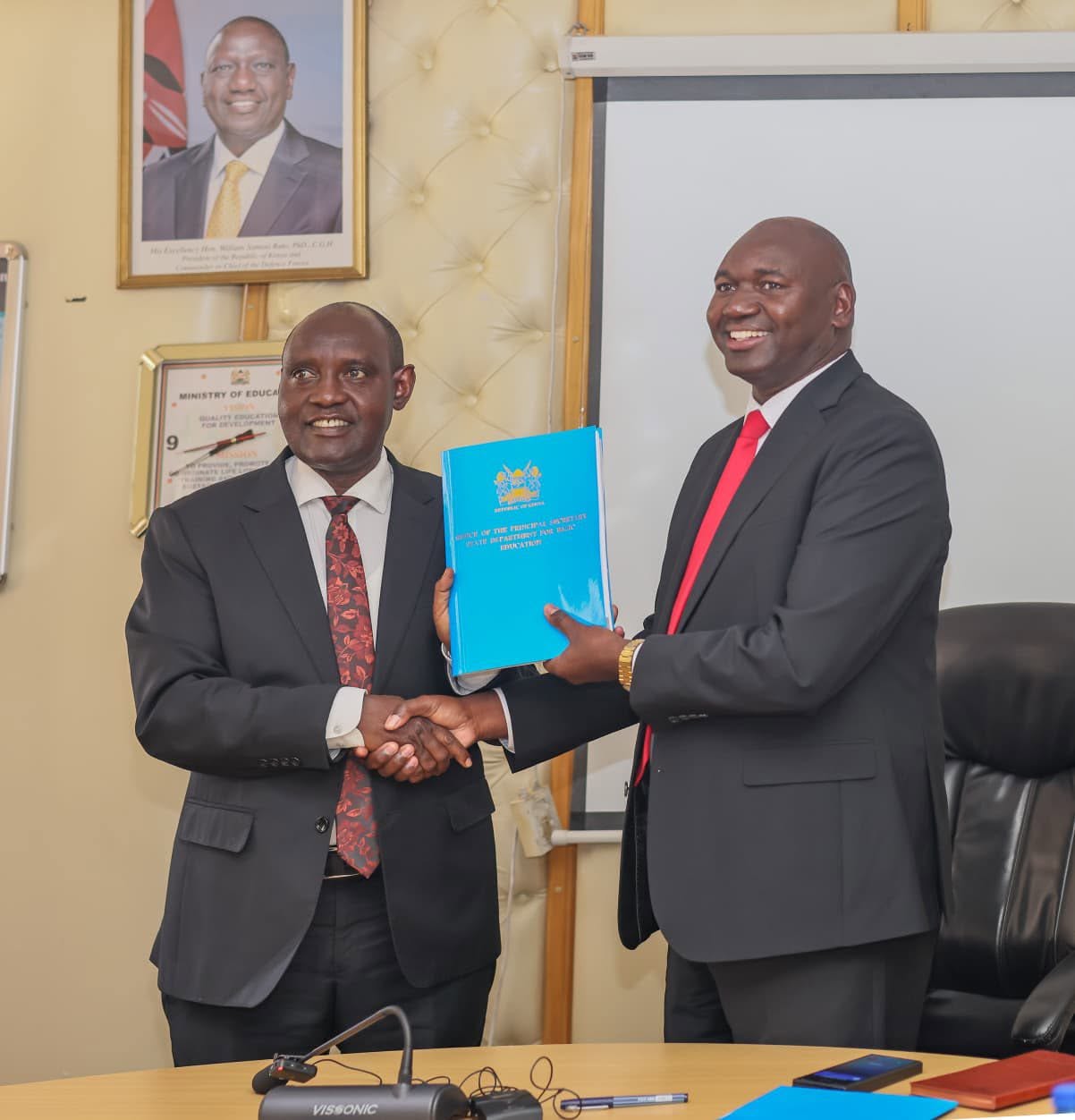 Outgoing Basic Education Principal Secretary Prof. Julius Bitok (right) hands over the State Department for Basic Education to his successor, John Lekakeny Ololtuaa, during a transition ceremony held on June 11, 2026, following the recent government reshuffle that reassigned the two Principal Secretaries. Picture/Courtesy of Julius Bitok