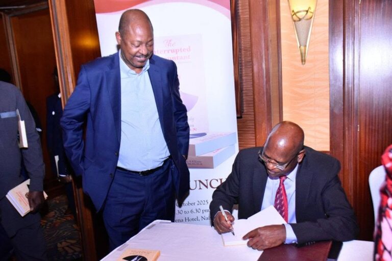 Philip Kinisu (seated) signs a copy of The Interrupted Accountant for an attendee during the book's launch at Serena Hotel, Nairobi, in 2025. Kinisu says he wrote the book to encourage young people that success is possible despite today's competitive environment. Picture/Free Press Publishers