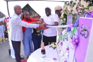 Valentine Cake House Founder and CEO Chef Mathew Gathua (second right) is joined by customers in cutting a cake to mark the bakery’s 25th anniversary. Picture/Courtesy